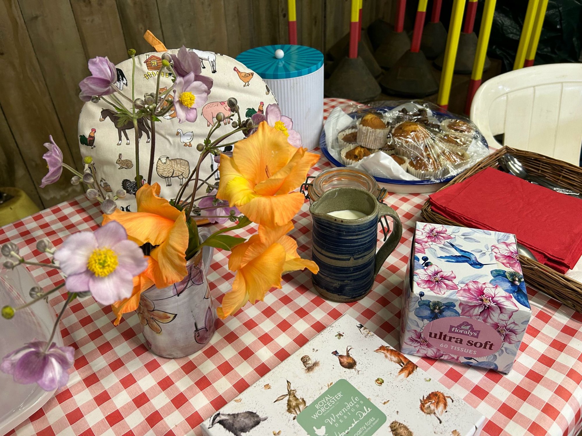 Tea with a Pony table setting — flowers, tea cosy, homemade cakes and a warm cuppa
